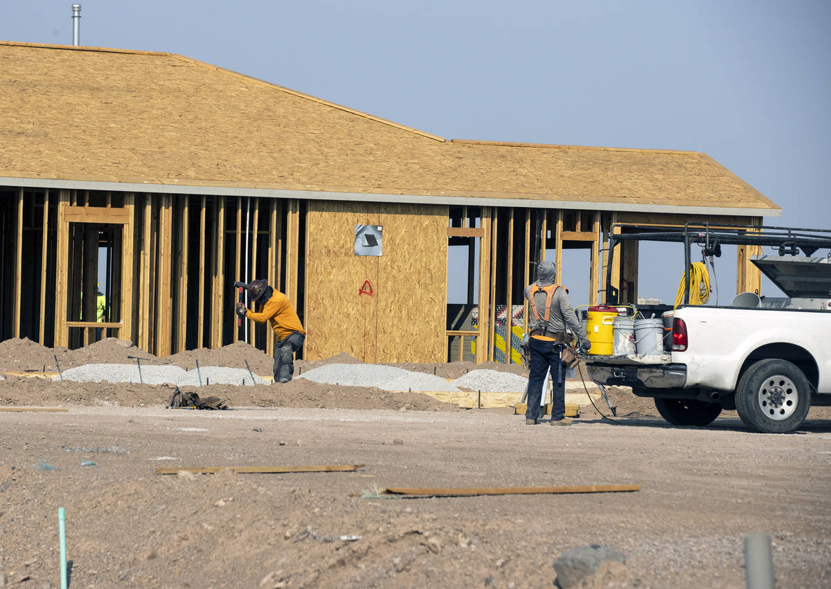 Construction crews work at the Rhapsody subdivision by developer StoryBook Homes in Henderson's ...