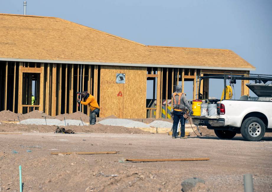 Construction crews work at the Rhapsody subdivision by developer StoryBook Homes in Henderson's ...