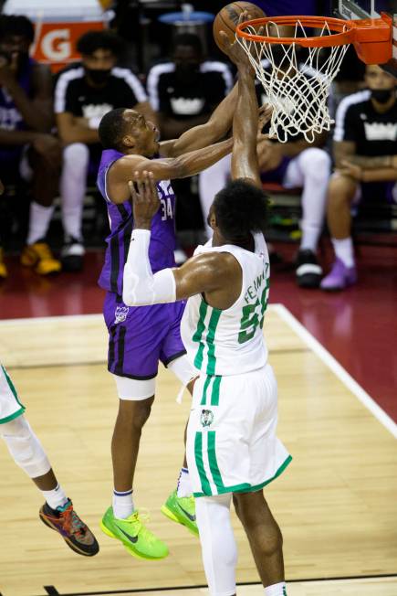 Sacramento Kings guard Matt Coleman III (34) goes for a layup while Boston Celtics forward Brun ...