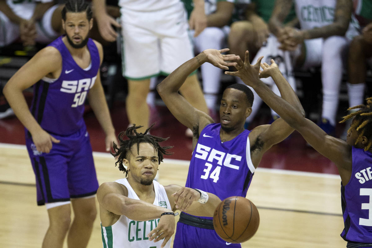 Boston Celtics guard Carsen Edwards (4) passes while Sacramento Kings guard DJ Steward, right, ...