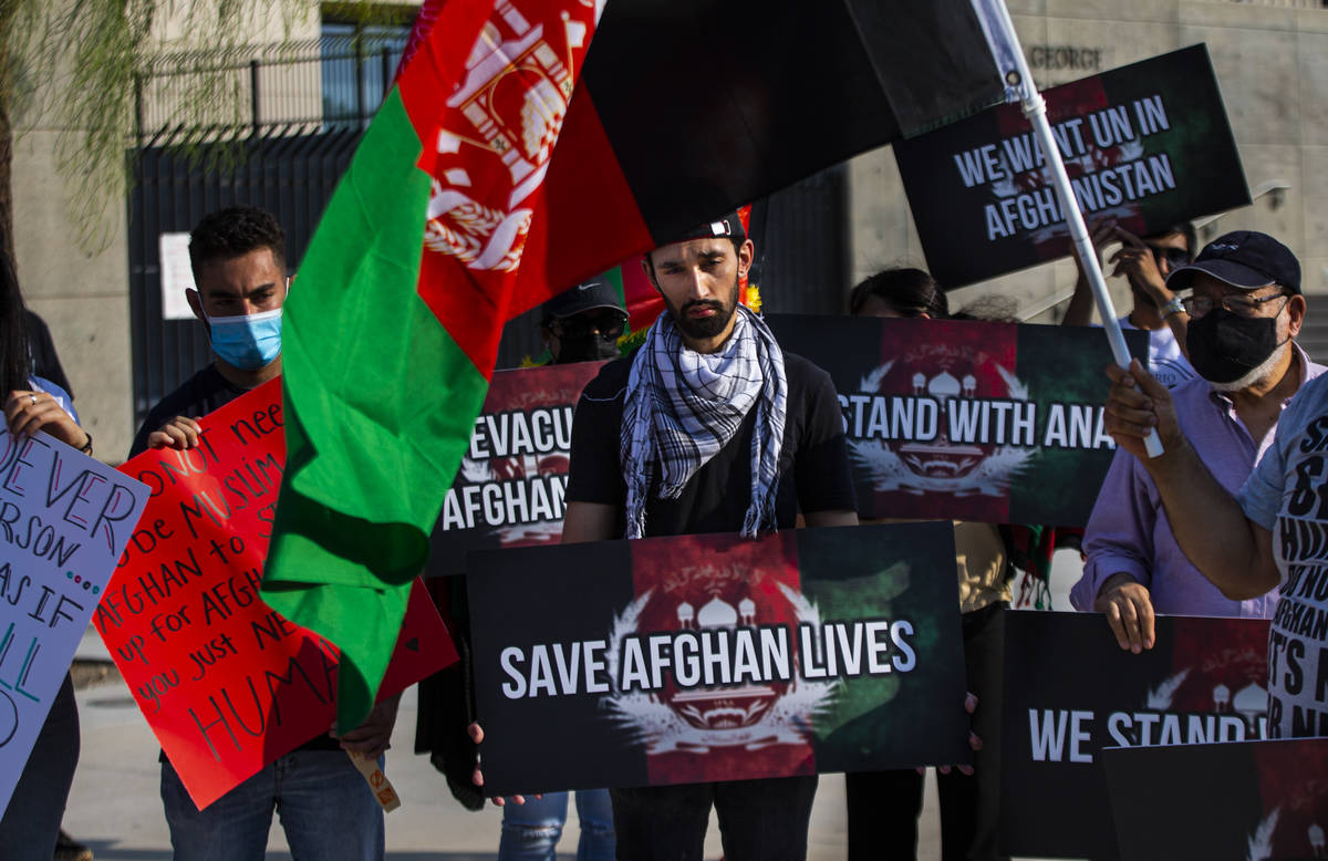 Wares Sarajzada holds a sign while participating in a protest against the Taliban and in suppor ...