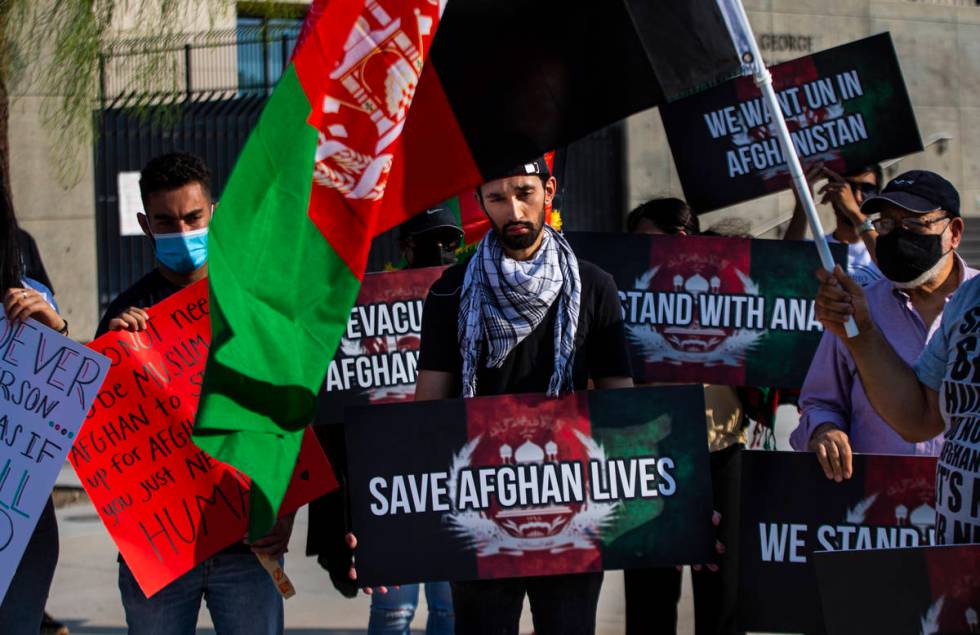 Wares Sarajzada holds a sign while participating in a protest against the Taliban and in suppor ...