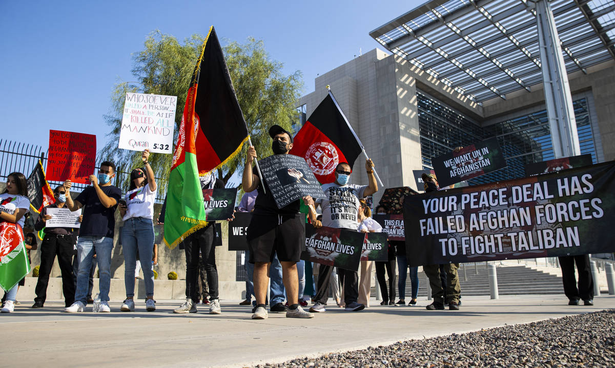 Elham Tamken, center left, participates during a protest against the Taliban and in support of ...