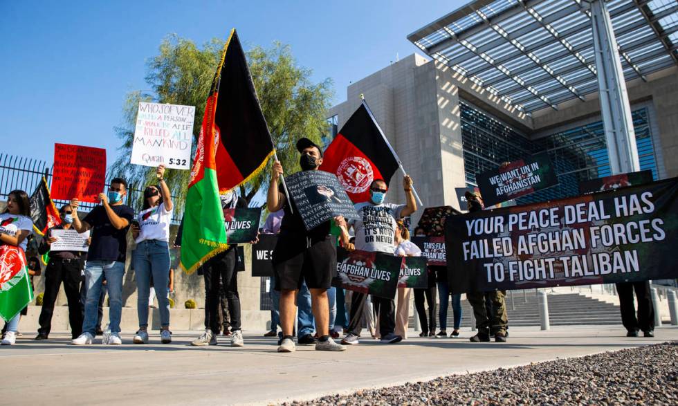 Elham Tamken, center left, participates during a protest against the Taliban and in support of ...