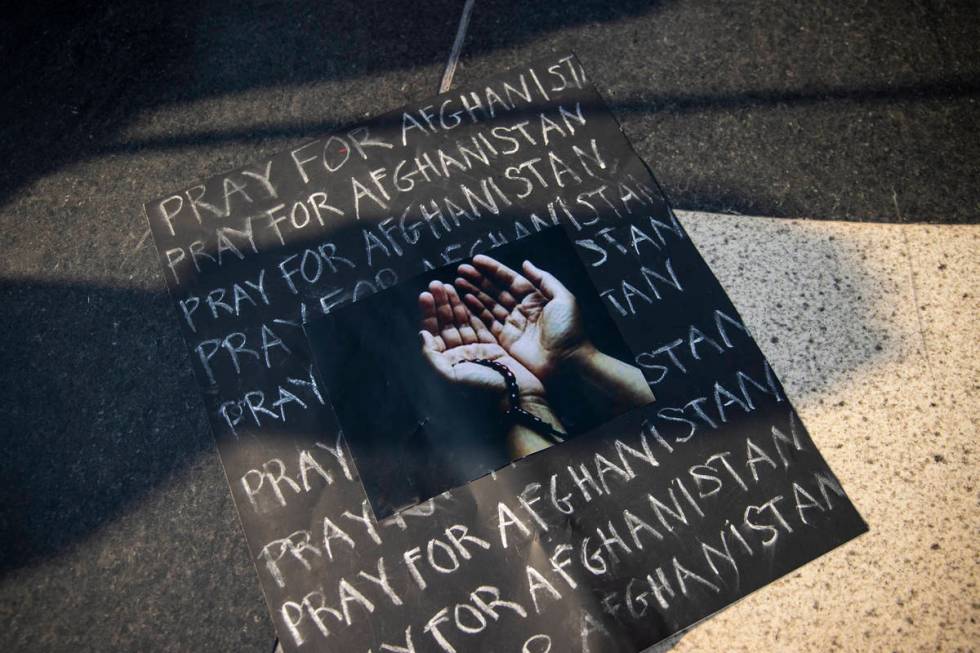 A sign is seen during a protest against the Taliban and in support of Afghanistan on Tuesday, A ...