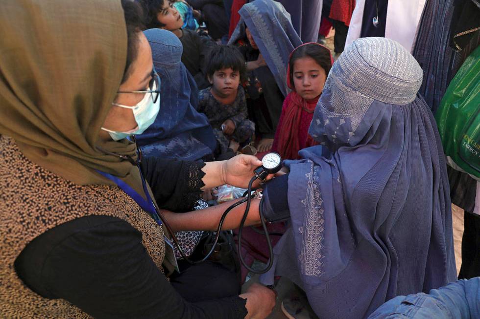 FILE - In this Aug. 10, 2021 file photo, an internally displaced woman from northern provinces, ...