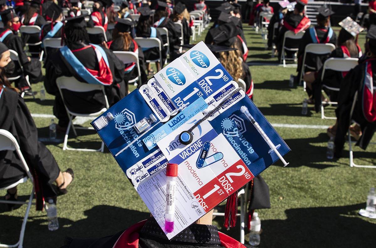 Talih Kadi decorates his graduation cap with COVID-19 and Pfizer themes during the first of sev ...