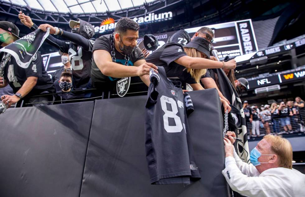 Raiders owner Mark Davis signs autographs for fans before the Raiders home opening pre-season N ...