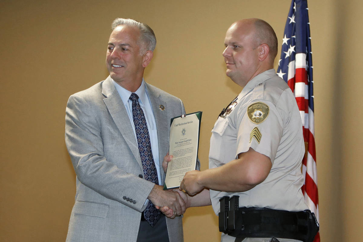 Sgt. Joseph Edens, right, poses for a photo with Clark County Sheriff Joe Lombardo after receiv ...