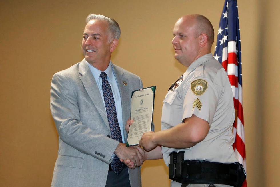 Sgt. Joseph Edens, right, poses for a photo with Clark County Sheriff Joe Lombardo after receiv ...