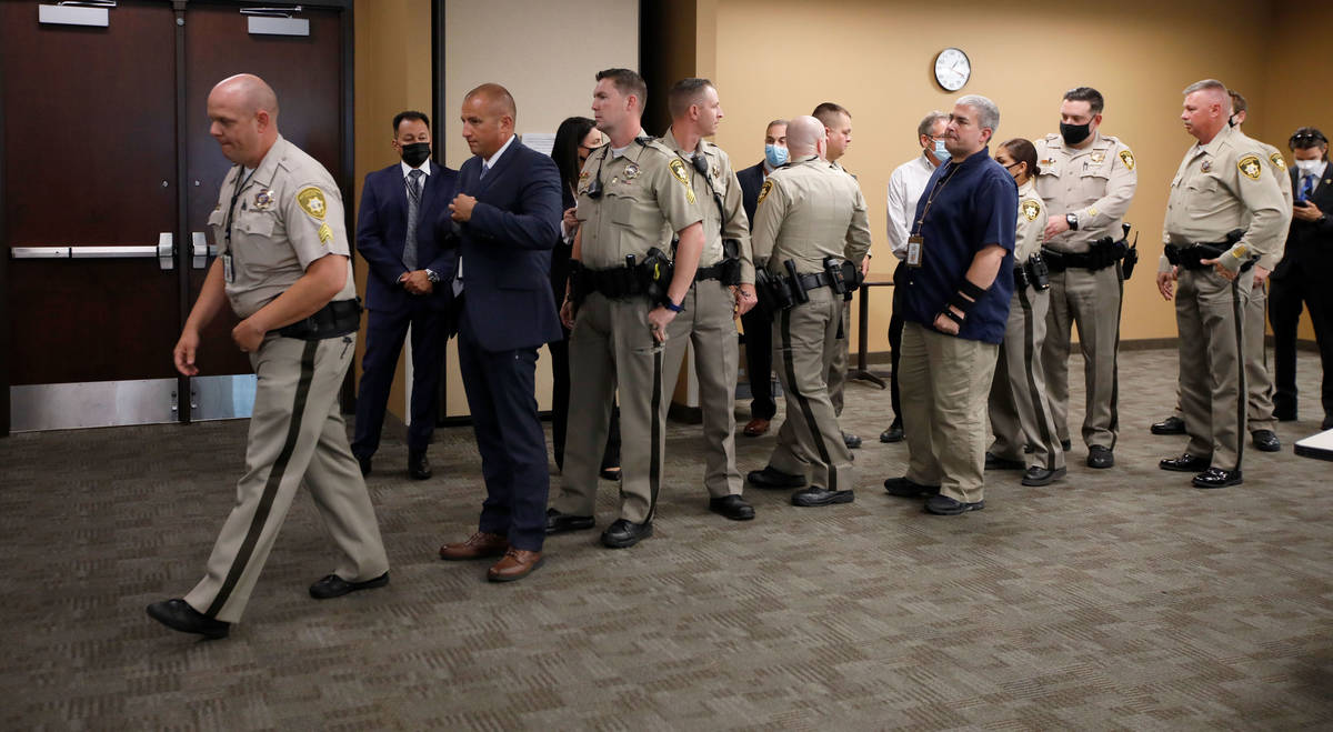 Sgt. Joseph Edens, left, and the unit members go to receive a unit meritorious service award du ...