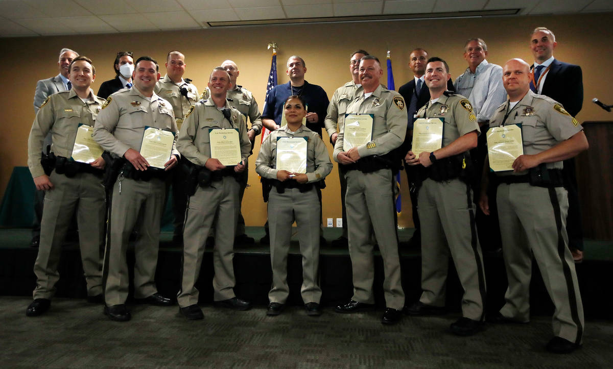 Clark County Sheriff Joe Lombardo, far left back, poses for a photo with the unit members who r ...