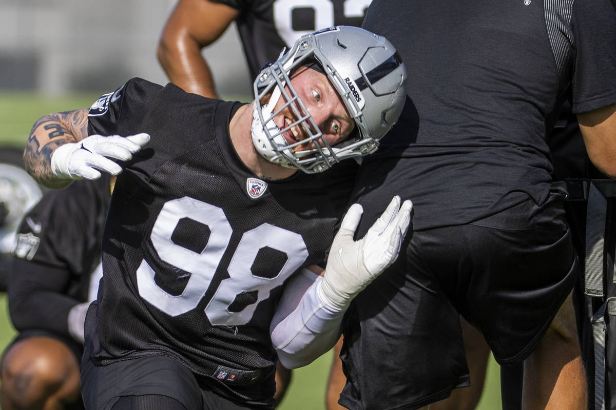 Raiders defensive end Maxx Crosby (98) moves around a coach on a drill during the Raiders train ...