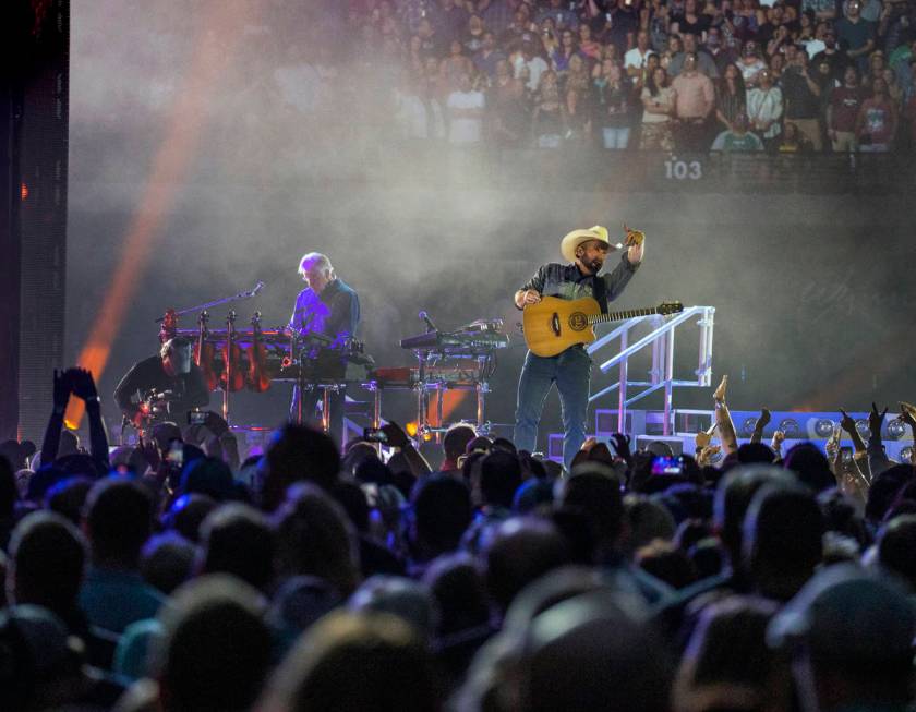 Garth Brooks signals the fans as he performs before the crowd at Allegiant Stadium on Friday, J ...