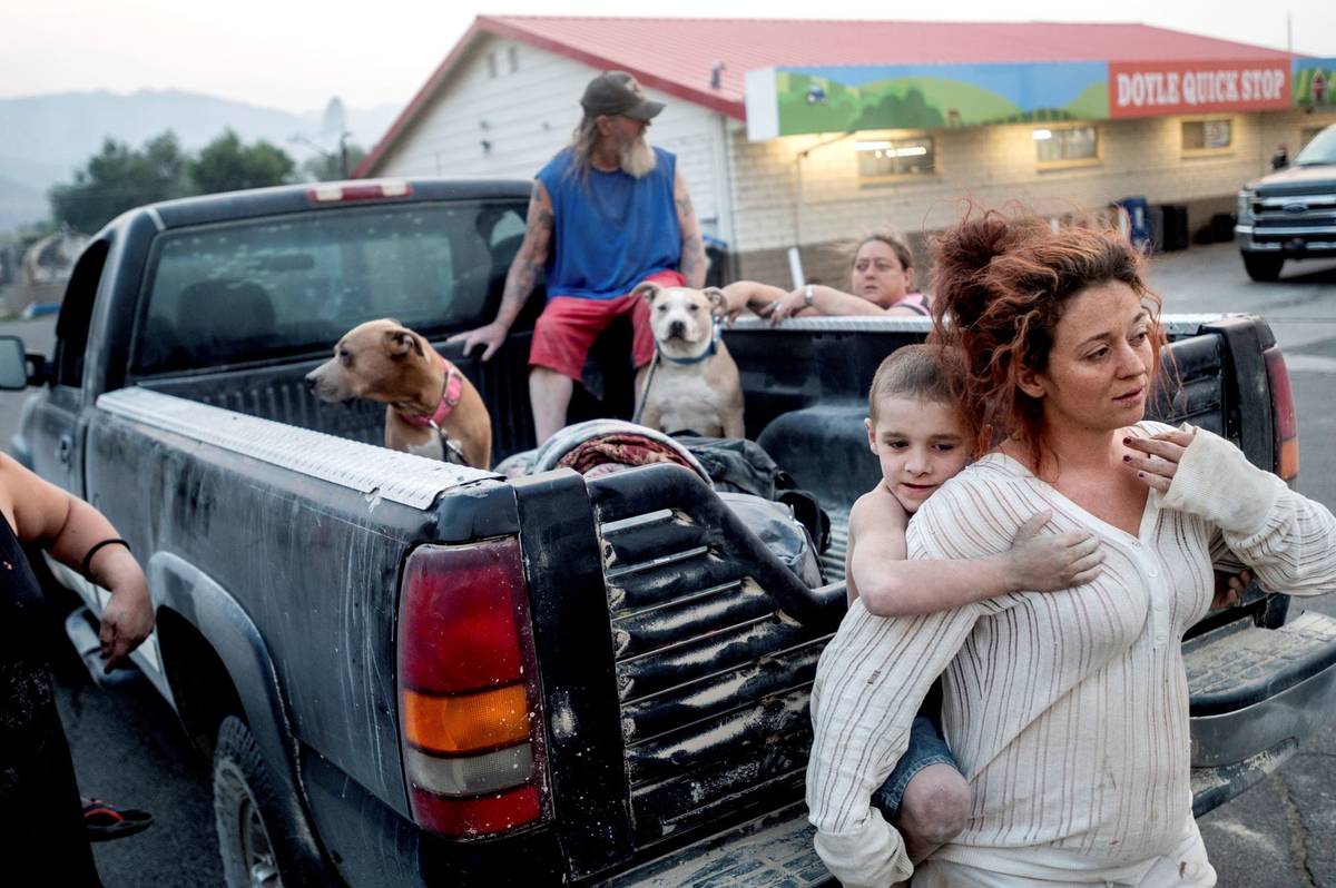 Destiney Barnard holds Raymond William Goetchius while stranded at a gas station near the Dixie ...