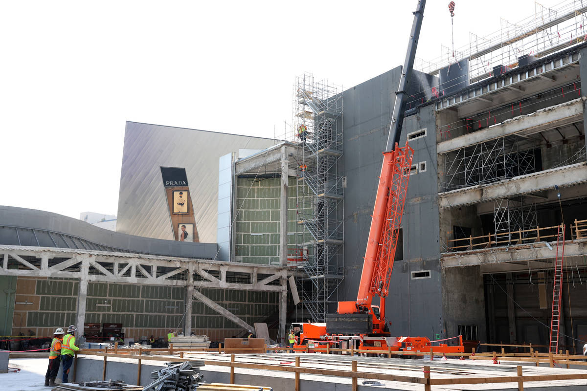 Workers dismantle the south core of the former Harmon hotel to make room for a four-story retai ...