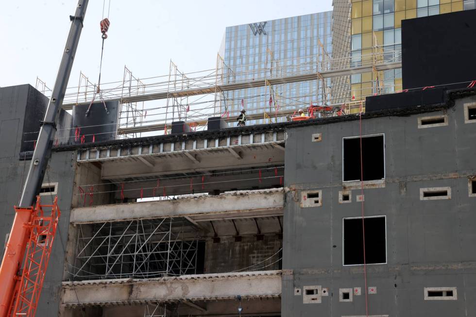 Workers dismantle the south core of the former Harmon hotel to make room for a four-story retai ...