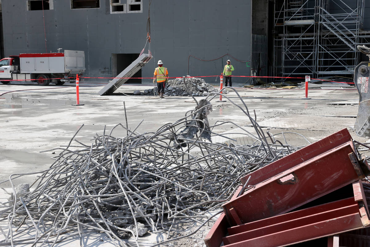 Workers dismantle the south core of the former Harmon hotel to make room for a four-story retai ...