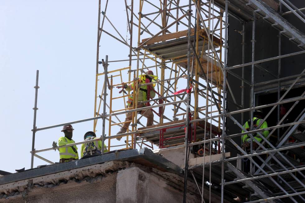 Workers dismantle the south core of the former Harmon hotel to make room for a four-story retai ...