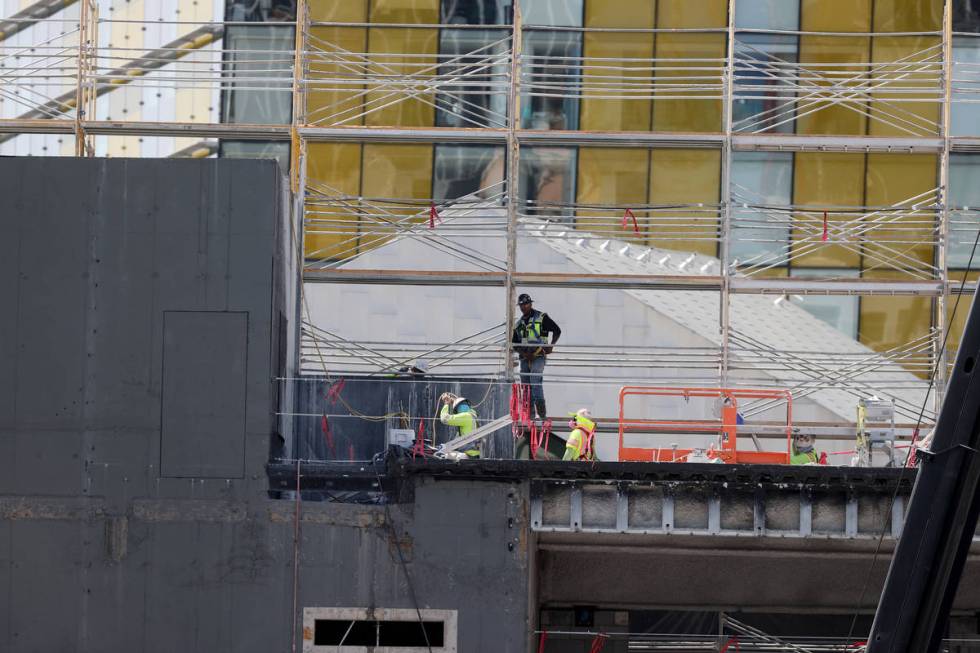 Workers dismantle the south core of the former Harmon hotel to make room for a four-story retai ...