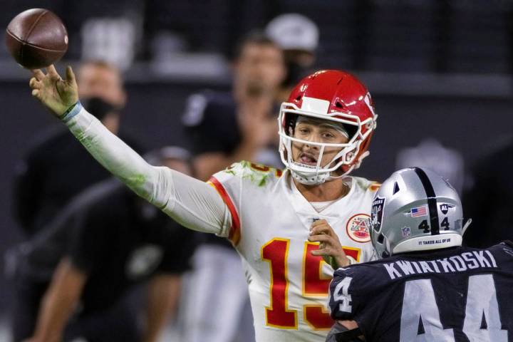 Kansas City Chiefs quarterback Patrick Mahomes (15) makes a running throw over Las Vegas Raider ...