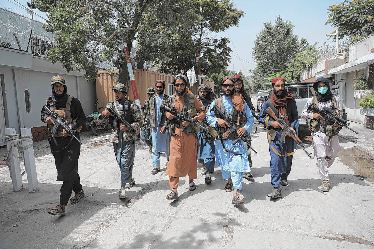 Taliban fighters patrol in the Wazir Akbar Khan neighborhood in the city of Kabul, Afghanistan, ...