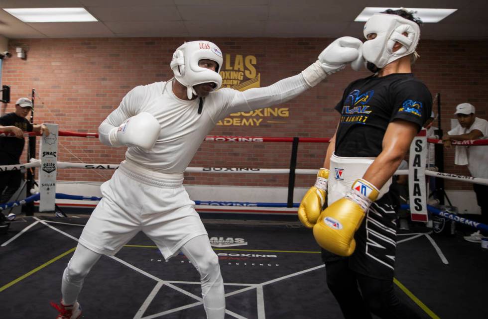 Welterweight Yordenis Ugas, left, trains for his upcoming fight with Manny Pacquiao on Monday, ...