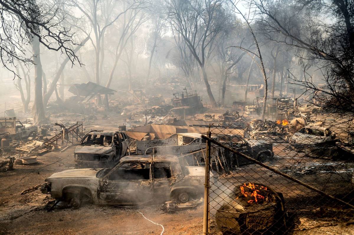 Scorched cars line a property as the Cache Fire burns on Wednesday, Aug. 18, 2021, in Clearlake ...