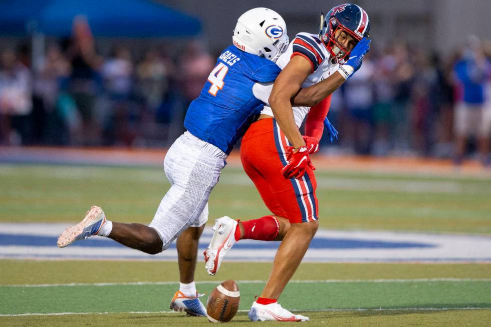 Bishop Gorman's Cam'ron Barfield (4 ) breaks a pass intended for St. Louis Devon Tauefa (4) du ...