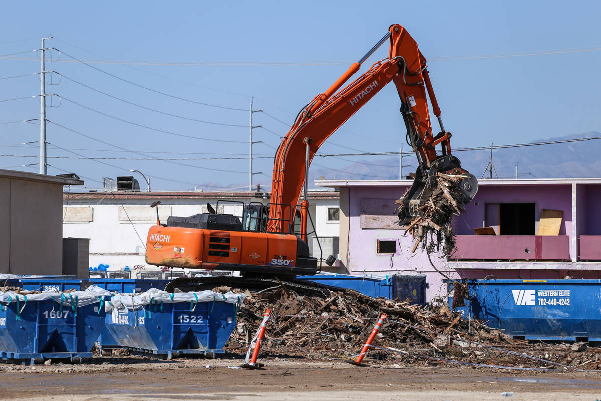 A crane lifts remnants of the demolished Moulin Rouge into dumpsters in Las Vegas, Thursday, Oc ...
