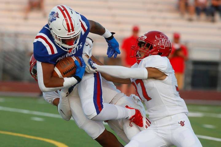 Liberty High School's Anthony Jones keeps a ball away from Arbor View High School's Aiden Powel ...