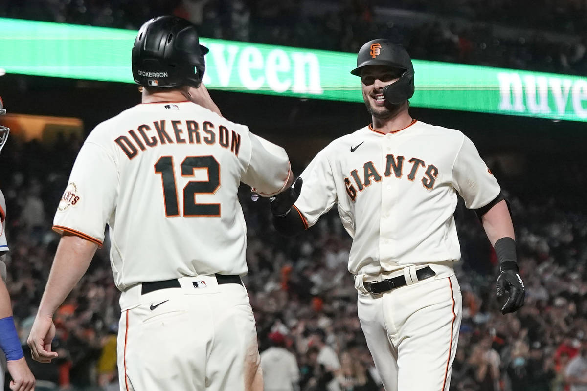 San Francisco Giants' Kris Bryant, right, celebrates after hitting a two-run home run that also ...