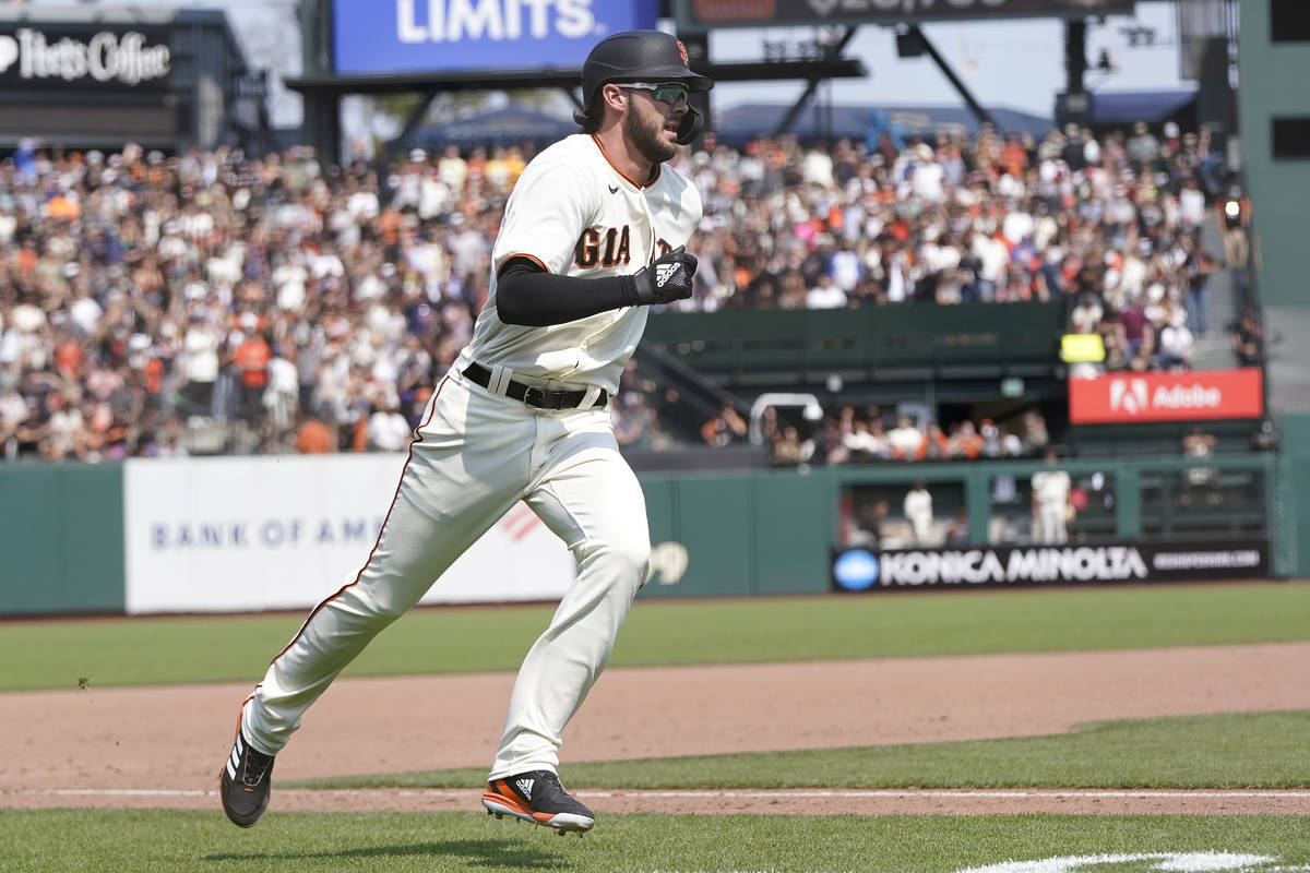San Francisco Giants' Kris Bryant runs home to score against the Colorado Rockies during the se ...