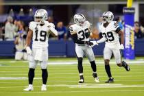 Las Vegas Raiders cornerback Nate Hobbs (39) celebrates his interception with Dallin Leavitt (3 ...