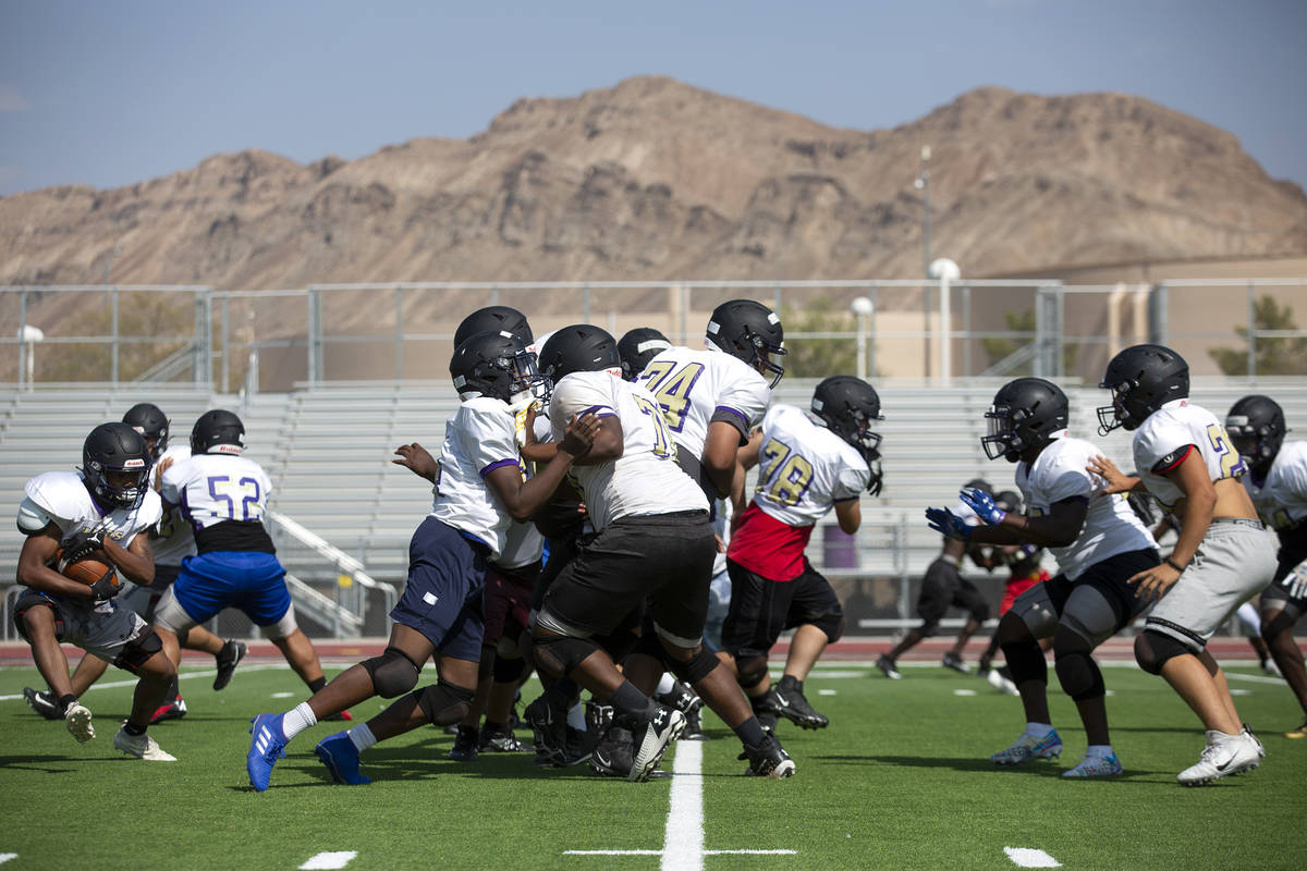 The Sunrise Mountain High School varsity football team practices at their school's field on Wed ...