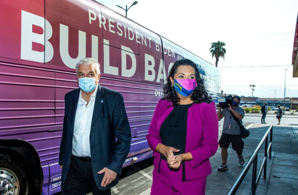 Gov. Steve Sisolak and Las Vegas Councilwoman Olivia Diaz walk by the bus after a tour of the E ...