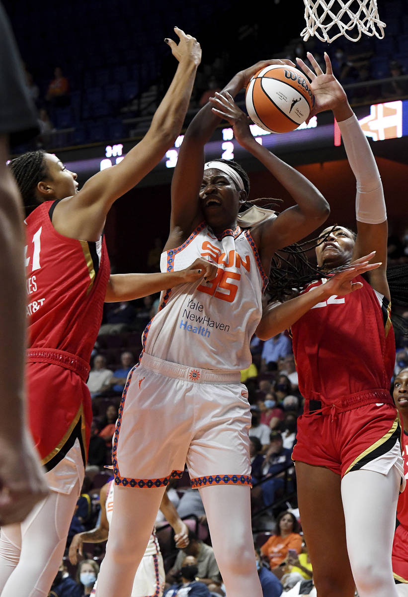 Connecticut Sun's Jonquel Jones (35) fights to keep control of the ball against Las Vegas Aces' ...