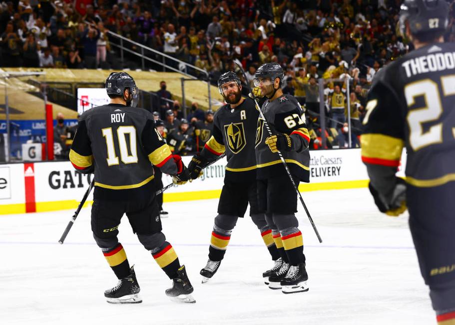 Golden Knights' Max Pacioretty (67) celebrates his goal with Nicolas Roy (10) and Alex Pietrang ...
