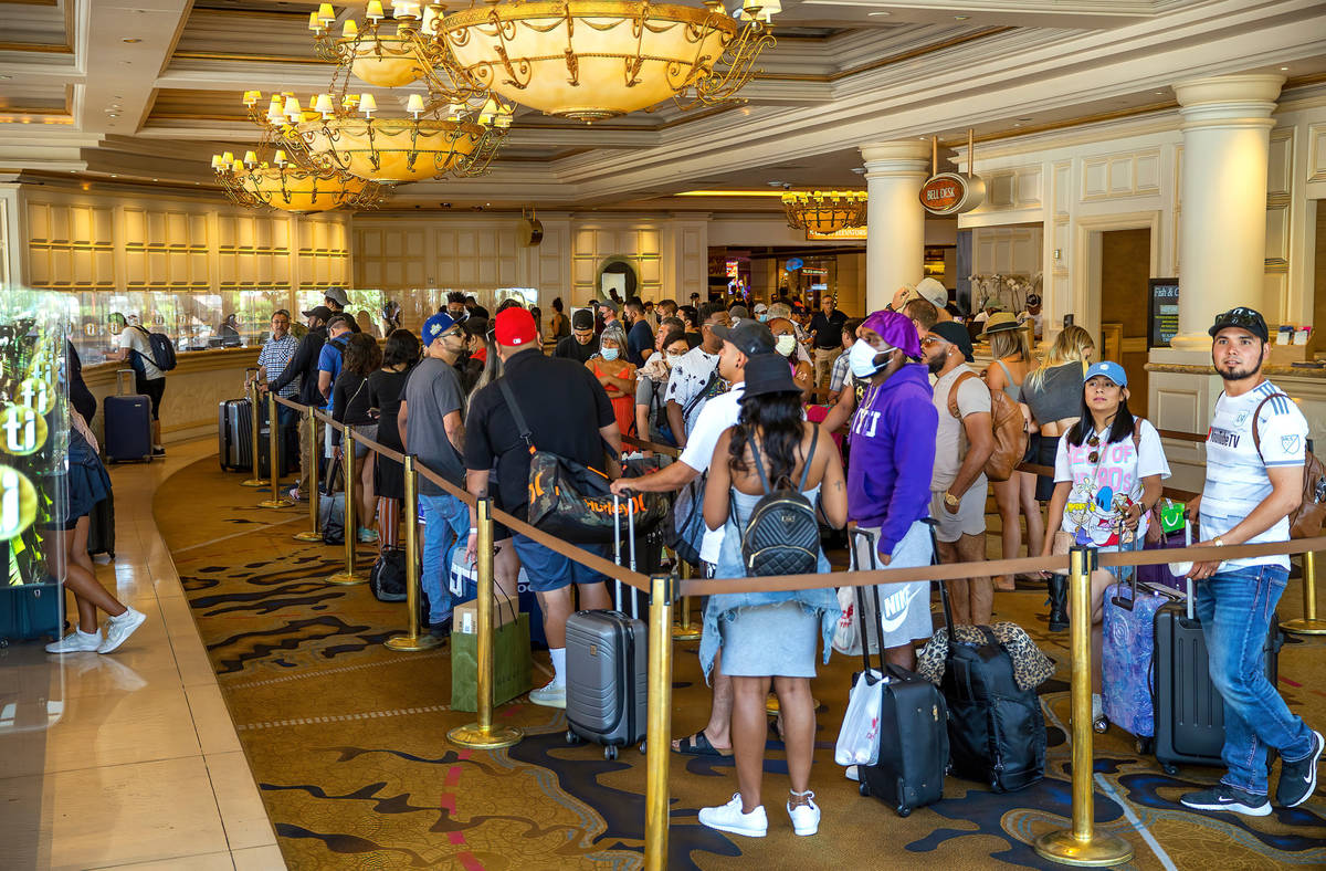 People stand in line to check in at treasure Island on Friday, July 16, 2021, in Las Vegas. ( ...
