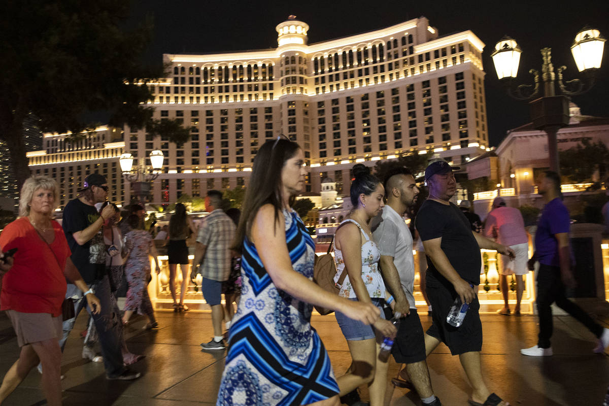 People walk past the Bellagio hotel-casino, on Saturday, July 10, 2021, in Las Vegas. (Bizuayeh ...