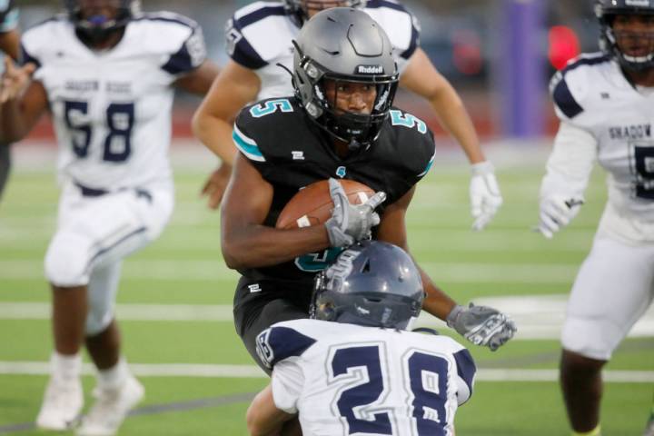 Silverado High School's Jaden Thrower (5) is tackled by Shadow Ridge High School's Dylan Wood ( ...