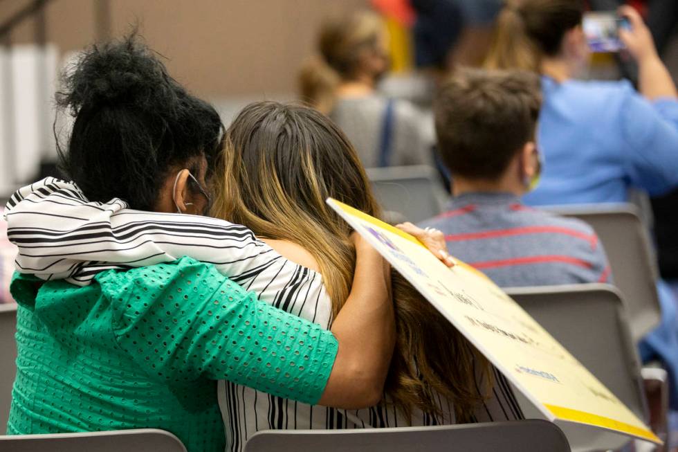 Audrey S. hugs a loved one while holding her check for $100,000 during the final Vax Nevada Day ...