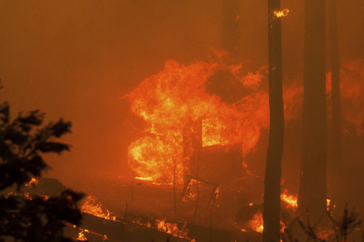 Flames from the French Fire consume a structure on Highway 155 in Sequoia National Forest, Cali ...