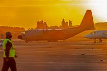 Military personnel walk by Belgian military planes, used as part of an evacuation from Afghanis ...