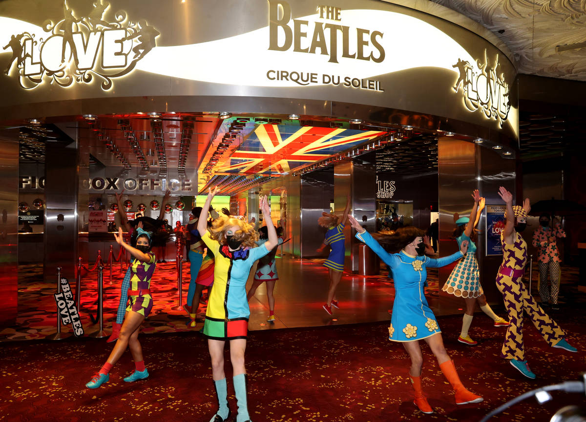 The cast of The Beatles LOVE entertain guests, employees, and fans during a celebratory pop-up ...