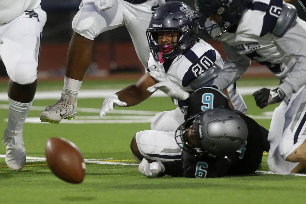 John-roan-kokou Agounke (6) fumbles the ball as Shadow Ridge High School's Devon Woods (20) loo ...