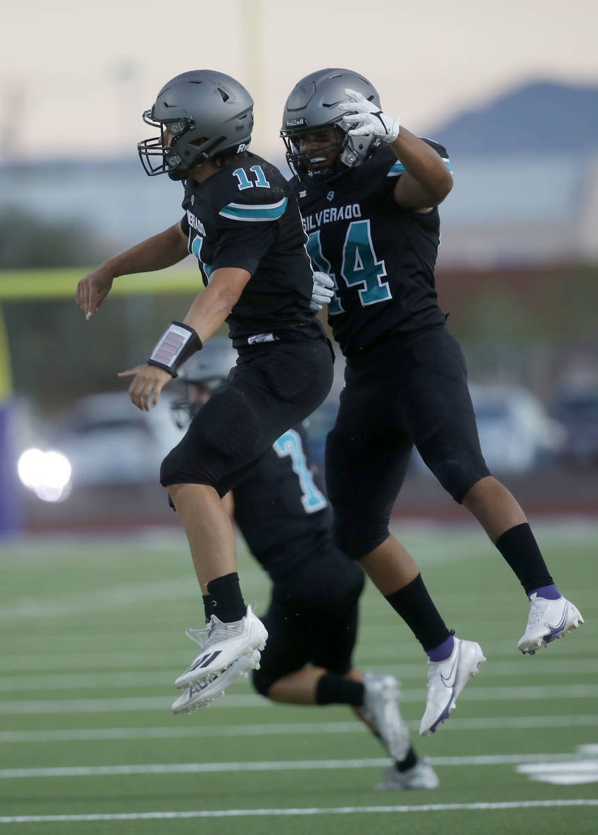 Silverado High School's Brandon Tunnell (11) celebrates his touchdown with Chris Federico (44) ...