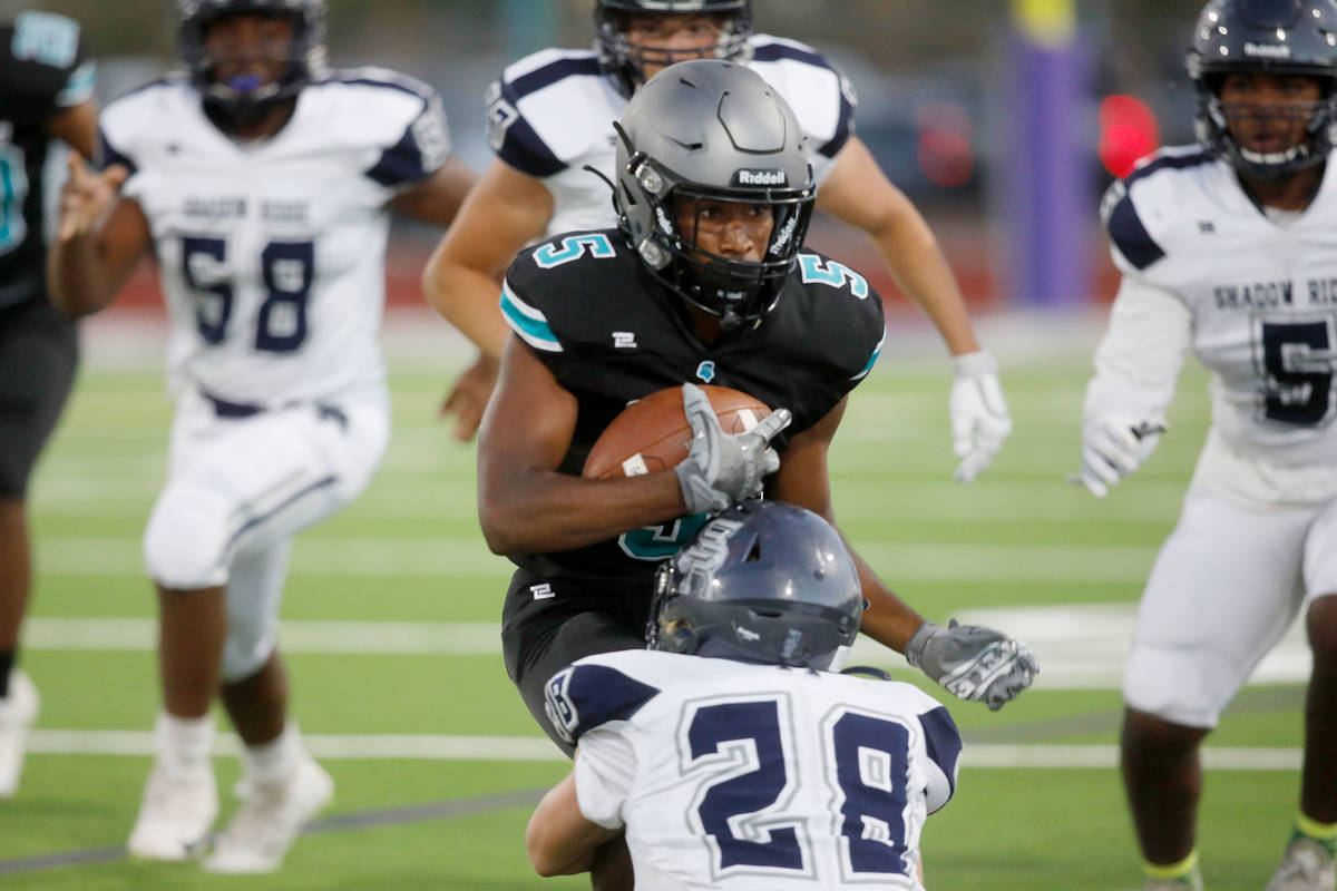 Silverado High School's Jaden Thrower (5) is tackled by Shadow Ridge High School's Dylan Wood ( ...