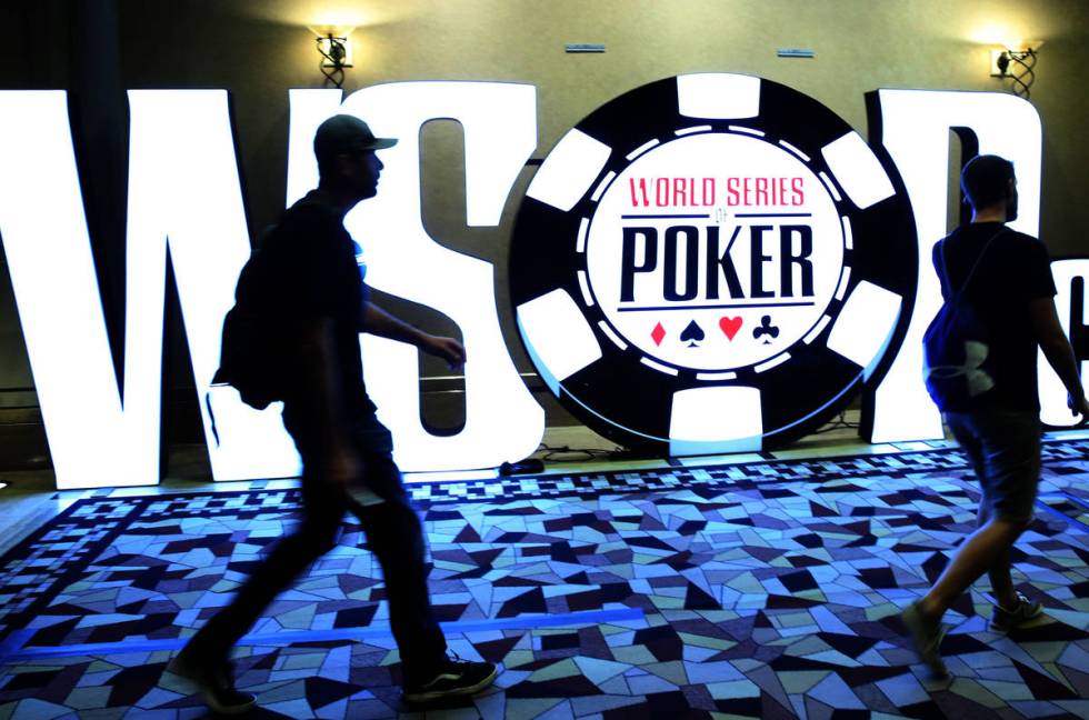 Players walk past the World Series of Poker Tournament (WSOP) sign during the 2019 WSOP tournam ...