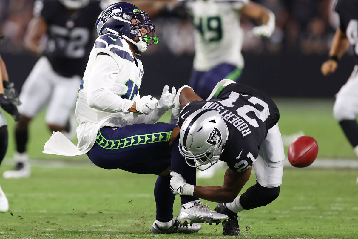 Seattle Seahawks wide receiver John Ursua (15) is tackled by Las Vegas Raiders cornerback Amik ...